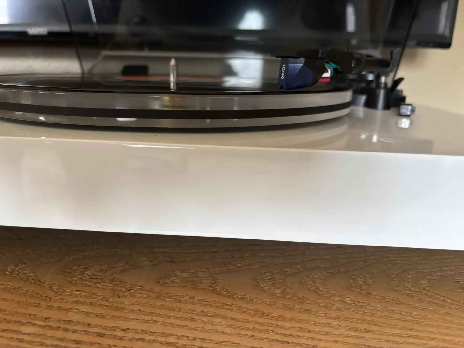 Flat vinyl record playing on a Fluance turntable with Ortofon 2M Blue cartridge properly tracking the groove